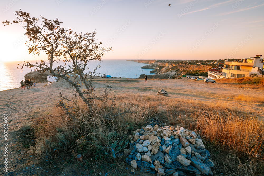 Sevastopol / Crimea - 23 Sep 2020: Crowds of tourists wait for the sunset on the observation deck of Cape Fiolent, a beautiful sea landscape