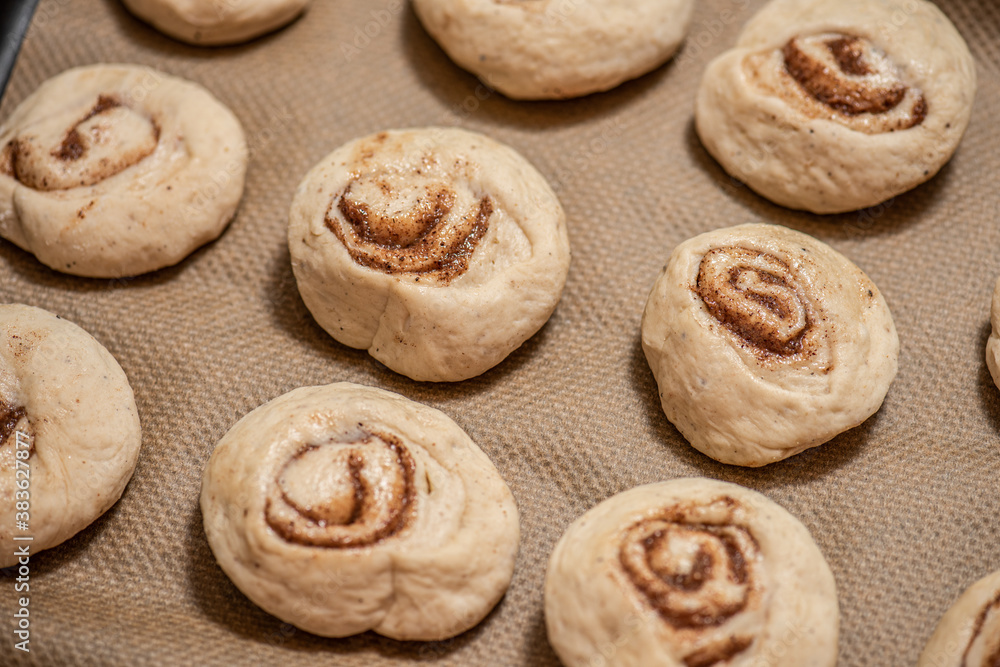 Cinnamon buns on a plate before baking