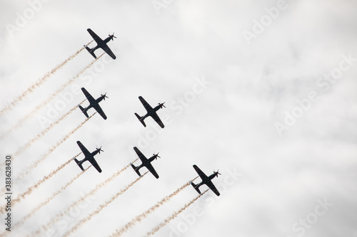 Fighter jets in the sky in airshow against clouds and sky precision flying machines against the sky clouds riding together team work collaboration close 