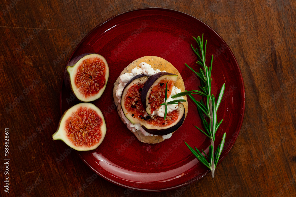 Fig dish with bread, rosemary and cream cheese on a plate Fig dish with bread, rosemary and cream cheese on a plate