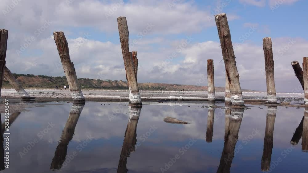 Drying Kuyalnik estuary. Salt crystals on wooden pillars of an old 18th century salt industry. The ecological problem is drought. Drying Kuyalnik estuary. Salt crystals on wooden pillars of an old 18th century salt industry. The ecological problem is drought.