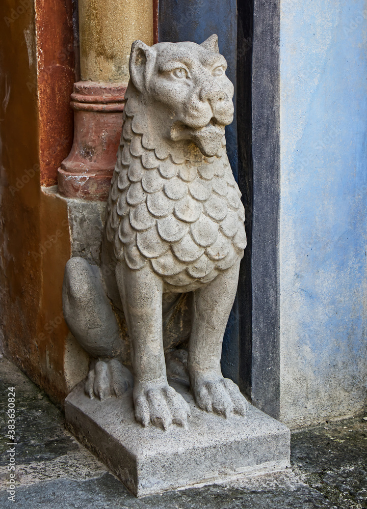 Lion statue near a passage door. Rocchetta Mattei. Bologna, Italy