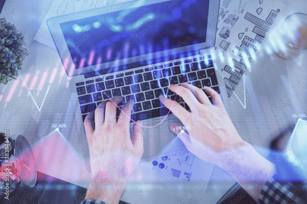 Double exposure of man's hands typing over laptop keyboard and forex chart hologram drawing. Top view. Financial markets concept. Double exposure of man's hands typing over laptop keyboard and forex chart hologram drawing. Top view. Financial markets concept.