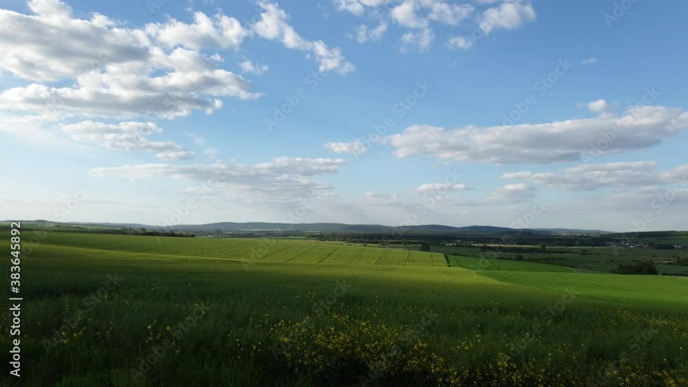 Clouds slowly passing over field of a rape seed Clouds slowly passing over field of a rape seed
