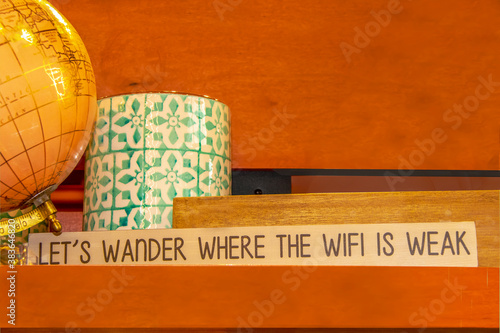 Foto Decorative world globe and sign that says Lets wander where the WIFI is weak on