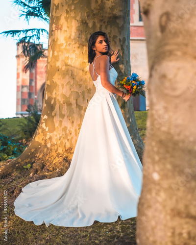 Tableau sur toile Caucasian brunette in wedding dress at sunset wedding celebration