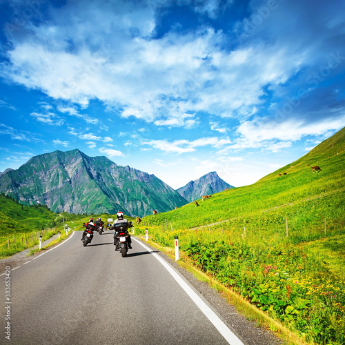 Motocyclists on countryside in mountains photo