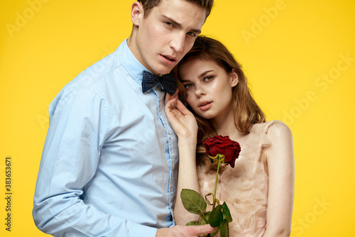romantic couple in love with red flower hugging each other cropped view Copy Space