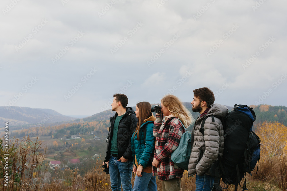 Friends are enjoying sunny autumn weather while hiking in the mountains Friends are enjoying sunny autumn weather while hiking in the mountains