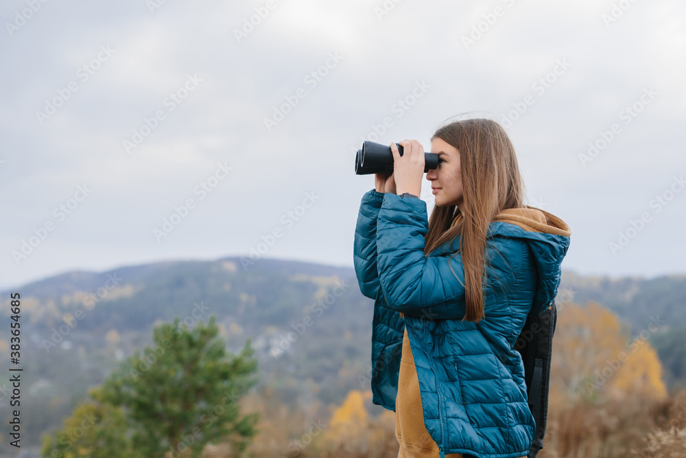 young traveler woman holding binoculars