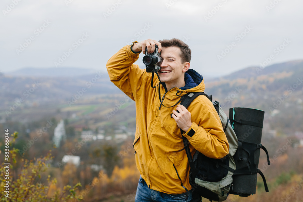 young traveler man with retro photo camera