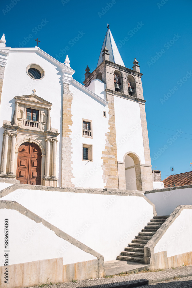 beautiful landscape of a large and tall church built of white stone. church in portugal. church with a tower with bells