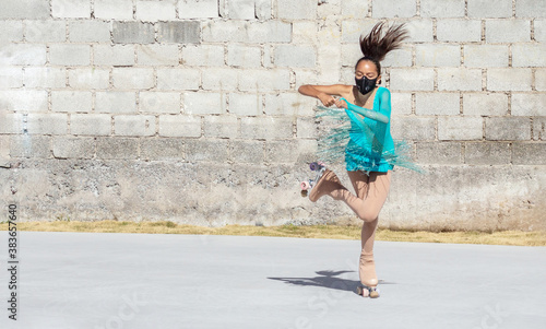 Teenage girl in mask performing figure skating spin