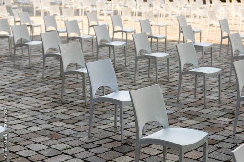 Outdoor business conference seating arranged for social distance. COVID-19 health and safety measures during pandemic require spacing between people