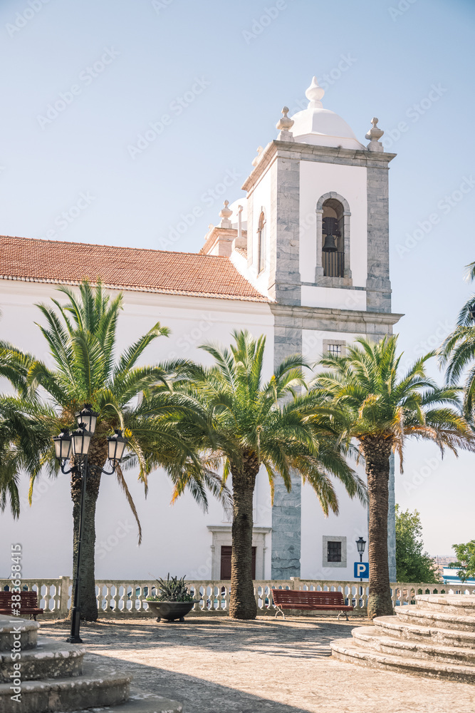 beautiful church built of stone. and a small park with palm trees. Church in Portugal