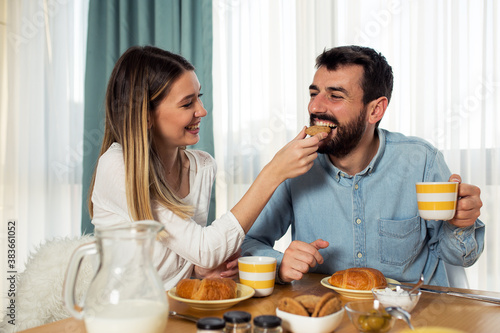 Sweet young couple have a breakfast at home