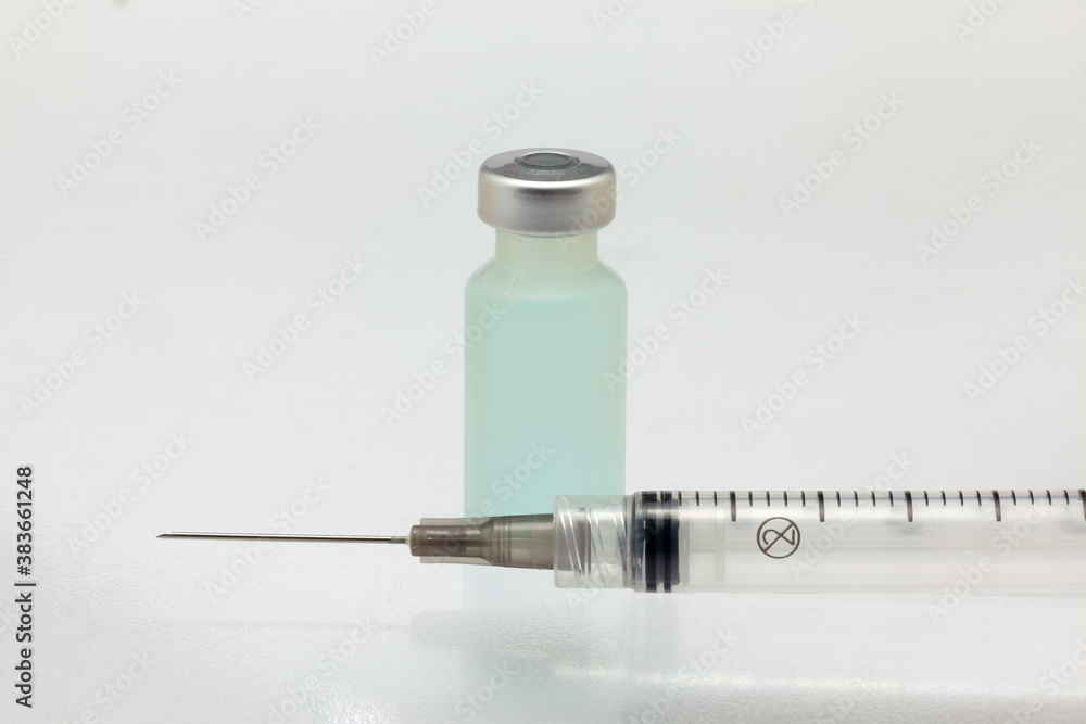 Isolated plastic vaccine bottle with colored liquid and needle syringe very close high magnification mockup Isolated plastic vaccine bottle with colored liquid and needle syringe very close high magnification mockup