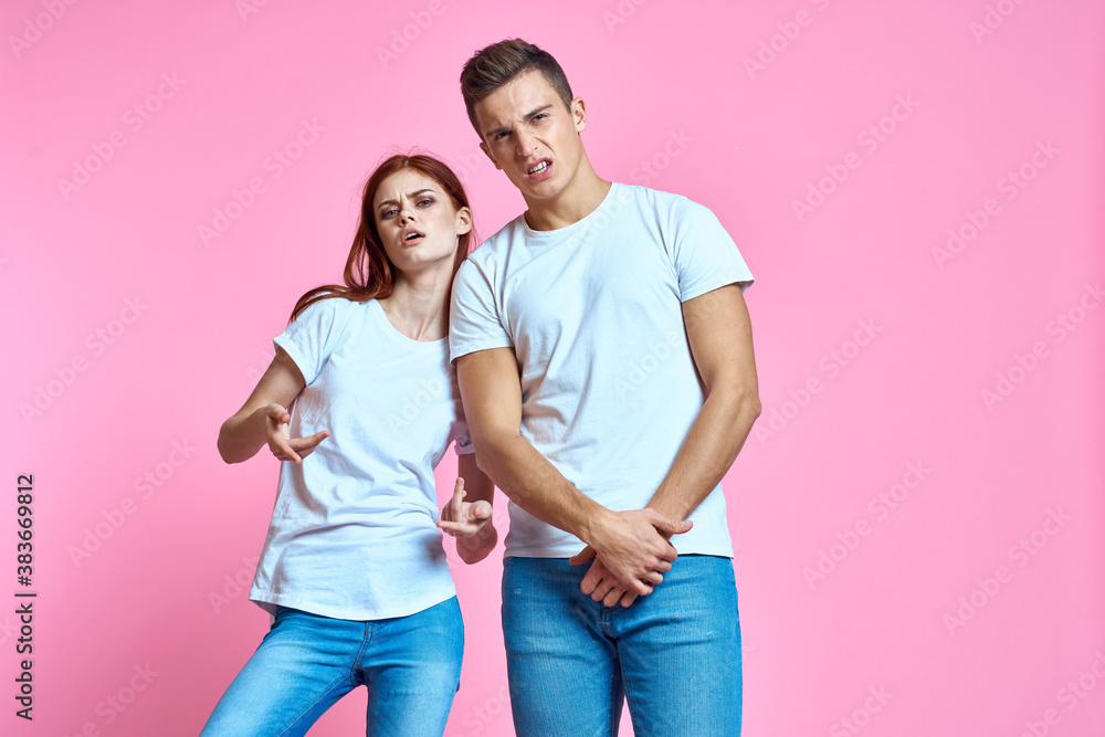 lovers man and woman in jeans and t-shirt on pink background cropped view family romance teenagers lovers man and woman in jeans and t-shirt on pink background cropped view family romance teenagers