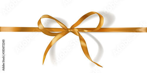 Golden bow made of narrow ribbon with shadow on white background. Horizontal arrangement