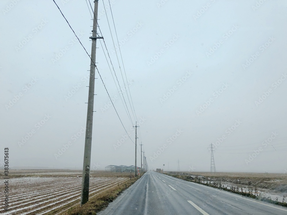 the winter scene: the road next to rice field in Yamagata Japan