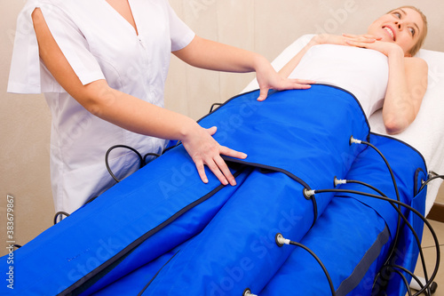 legs pressotherapy machine on woman in beauty center