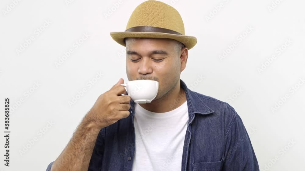 Asian man smelling and drinking coffee. A young man tasting a cup of favorite hot coffee on isolated white background. 4K Resolution. Asian man smelling and drinking coffee. A young man tasting a cup of favorite hot coffee on isolated white background. 4K Resolution.