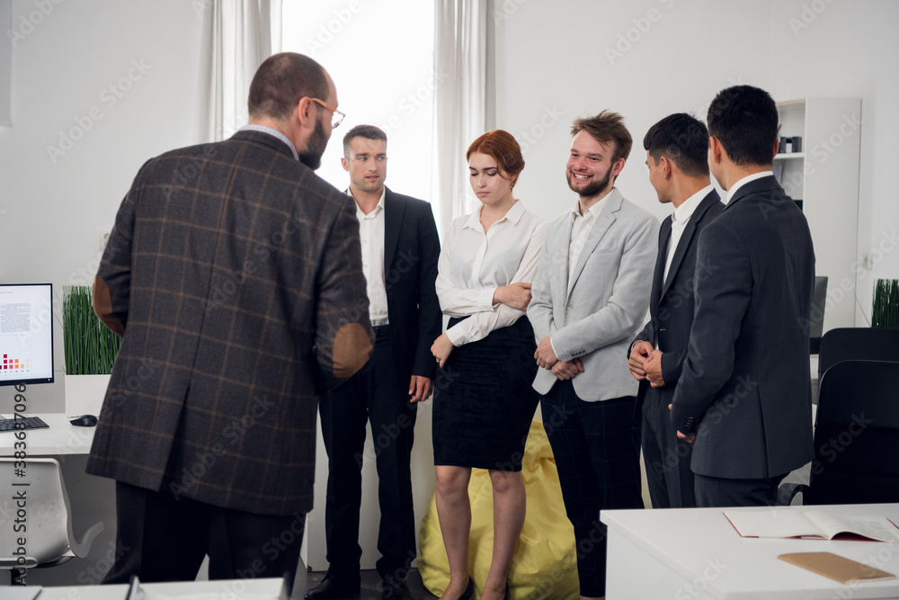 Young promising employees of an international it company communicate and share financial news during a break. Young promising employees of an international it company communicate and share financial news during a break.