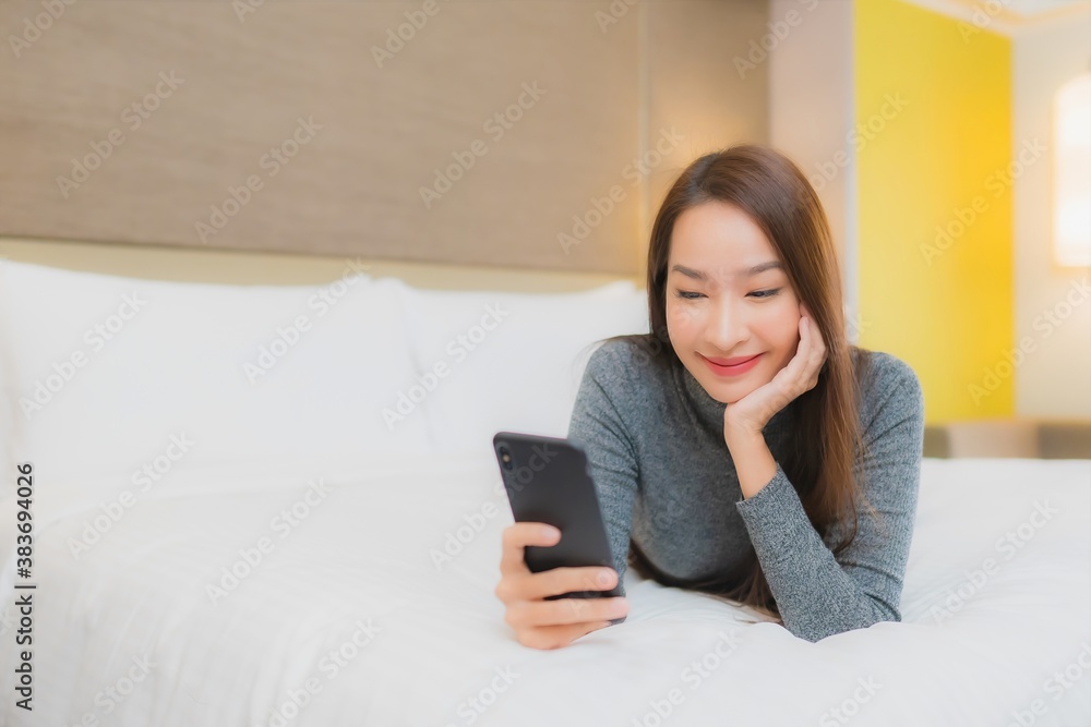 Portrait beautiful young asian woman use smart mobile phone on bed Portrait beautiful young asian woman use smart mobile phone on bed