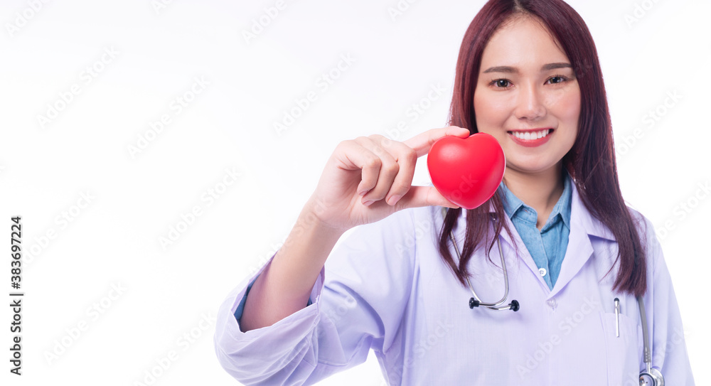 Selective focus hand of friendly doctor woman wear uniform with stethoscope hold red heart, representing giving all effort to deliver high quality service mind patient over isolated white background Selective focus hand of friendly doctor woman wear uniform with stethoscope hold red heart, representing giving all effort to deliver high quality service mind patient over isolated white background
