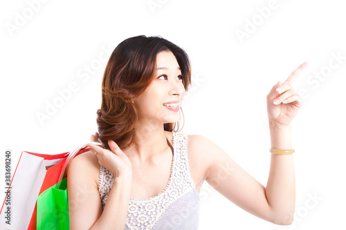 happy young woman with shopping bagand pointing something photo