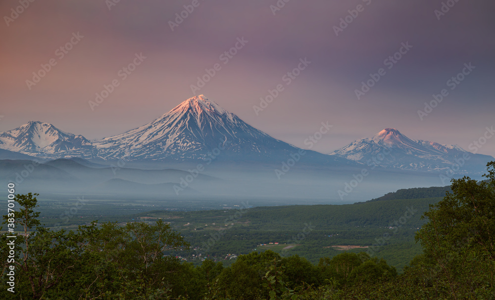 Kamchatka, a group of volcanoes: Arik, Koryaksky, Avachinsky at sunset