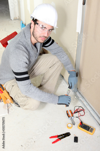 Electrician installing wiring