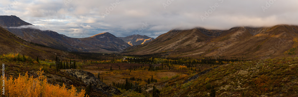 Beautiful Panoramic View of Colourful Fall Forest and Mountains in Tombstone on a Cloudy Morning. Tombstone Territorial Park, Yukon, Canada. Nature Background Panorama