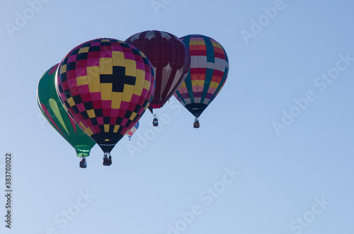 A cluster of hot air balloons in flight.