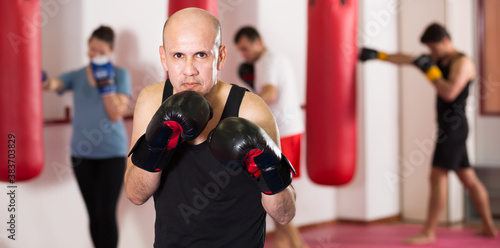 .Professional boxer trains in boxing gloves in the gym