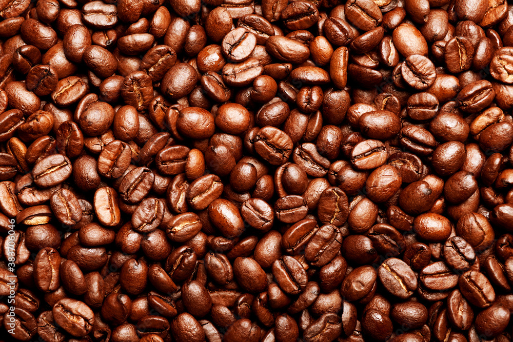 Freshly roasted coffee beans background. Texture of coffee beans. Energy stimulant and smooth java concept with full frame photograph of piled roasting coffee beans backgrounds. Freshly roasted coffee beans background. Texture of coffee beans. Energy stimulant and smooth java concept with full frame photograph of piled roasting coffee beans backgrounds.