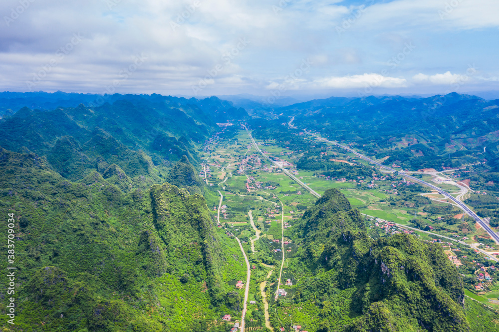 aerial view of cityscape and nature with green fields and mountains in Chi Lang, Lang Son, Vietnam.