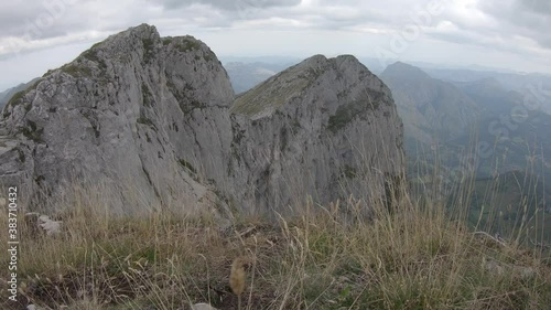 Reveal of breathtaking mountain peak covered by clouds, Tiatordos trek in Redes Natural Park, Asturias photo