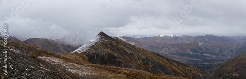 Panoramic View of Scenic Landscape and Mountains in Canadian Nature. Season change from Fall to Winter. Taken in Tombstone Territorial Park, Yukon, Canada.