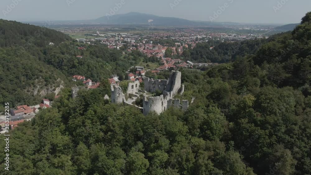 Aerial shot flying smooth slow over the historical castle of Samobor surrounded by green trees and city buildings in the background. Aerial shot flying smooth slow over the historical castle of Samobor surrounded by green trees and city buildings in the background.