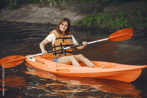 Kayaking. A woman in a kayak. Girl paddling in the water.