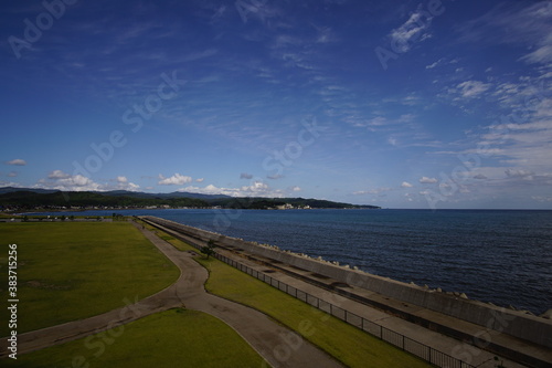 Green park near sea front with ocean on the background. Toyama, Japan.