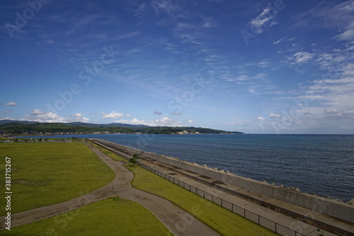 Green park near sea front with ocean on the background. Toyama  Japan.