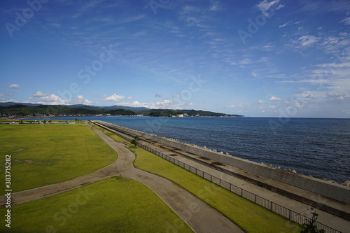Green park near sea front with ocean on the background. Toyama  Japan.