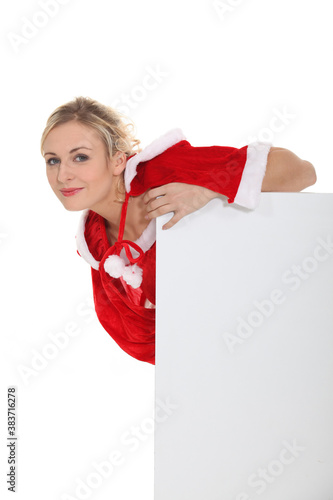 Woman leaning on a blank poster photo