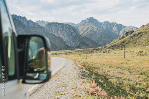 Parked car on auto road against beautiful mountain landscape, Chemalsky tract, Altai