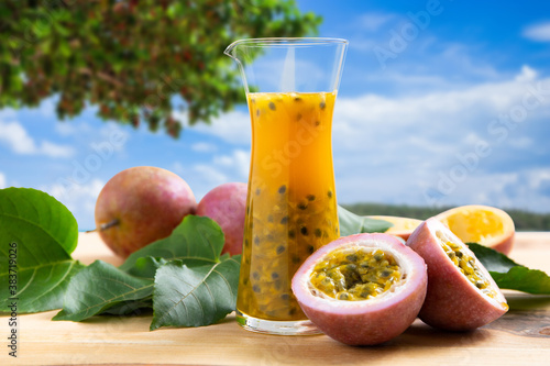 Passion fruits half and juice on the beach.