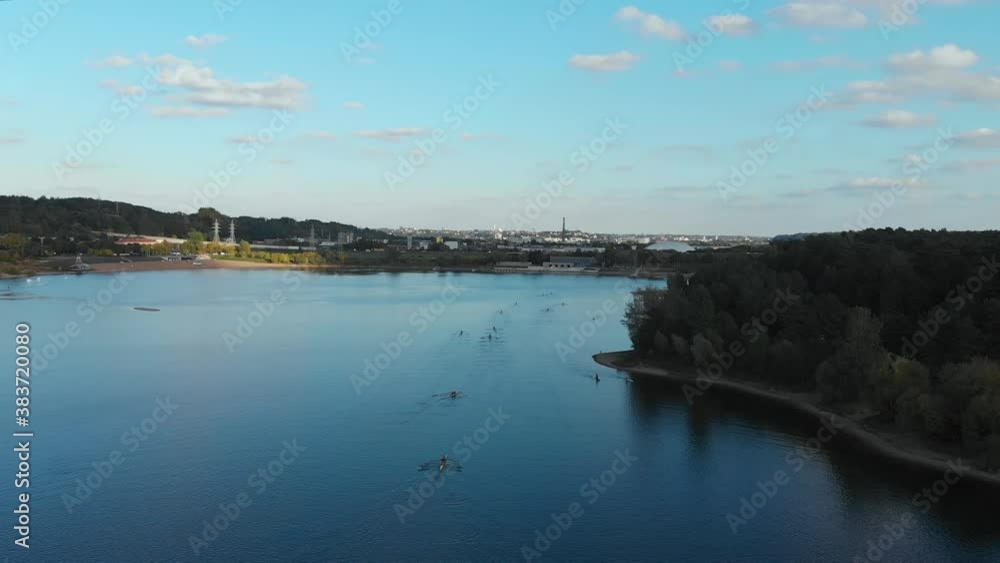 Many kayaks going to shore, aerial lowering. Many kayaks going to shore, aerial lowering.