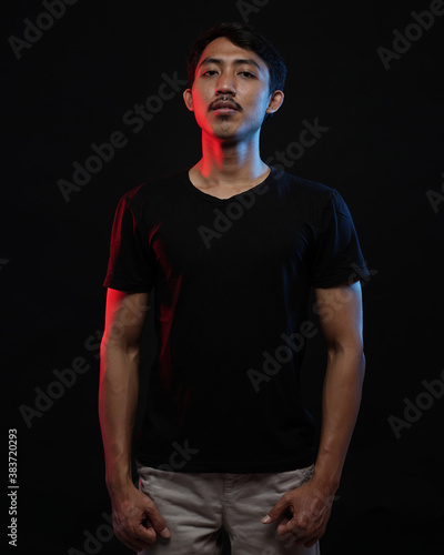 Young men in empty black T-shirts, stylish and posing like famous T-shirt models. Men's t-shirt template and mockup design for print.