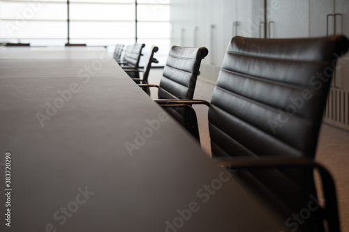 A conference business room for training and business activities with desks and chairs set up for learning and education. Work place office environment.  photo
